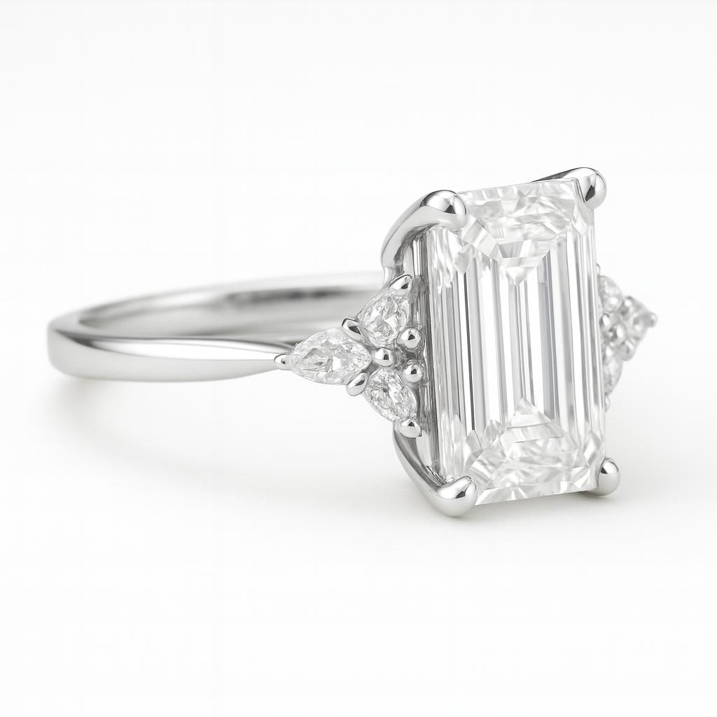 10 CT Lab Grown Emerald Cut Diamond Ring with Pear Side Stones in 14K White Gold: Magnificent 10 carat lab grown emerald cut diamond centerpiece, accented by a pair of lab grown pear-shaped side stones. Expertly crafted in 14K white gold with a sleek high-polish finish, creating a 