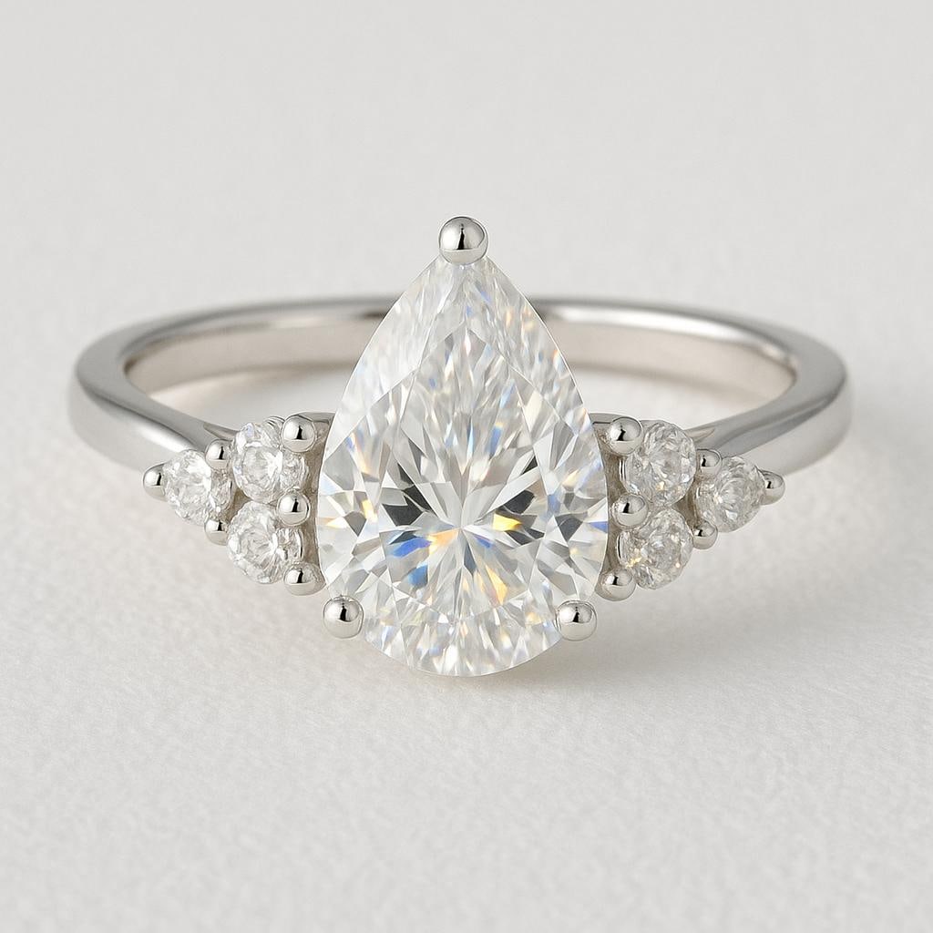 5 CT Lab Grown Pear Cut Diamond Ring with Round Side Stones in 14K White Gold: Stunning 5 carat lab grown pear cut diamond centerpiece, accented with clusters of lab grown round brilliant side stones. Expertly crafted in 14K white gold with a high-polish finish, offering timeles
