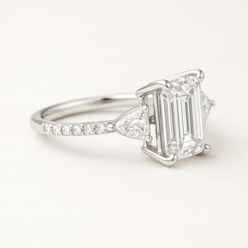 4.50 CT Lab Grown Emerald Cut Diamond Ring with Trillion Side Stones & Pavé Band in 14K White Gold: Elegant 4.50 carat lab grown emerald cut diamond centerpiece, flanked by trillion cut side stones. The pavé-set diamond band in 14K white gold adds extra brilliance, offering a timeless and luxurious