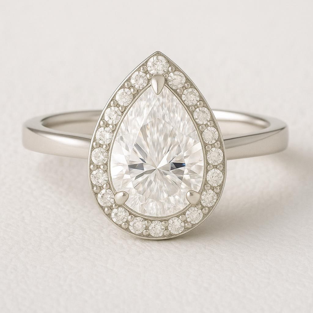 4.00 CT Lab Grown Pear Cut Diamond Halo Engagement Ring in 14K White Gold: Elegant 4.00 carat lab grown pear cut diamond centerpiece, surrounded by a halo of pavé-set round diamonds for added brilliance. Crafted in 14K white gold with a polished finish, this ring combines s