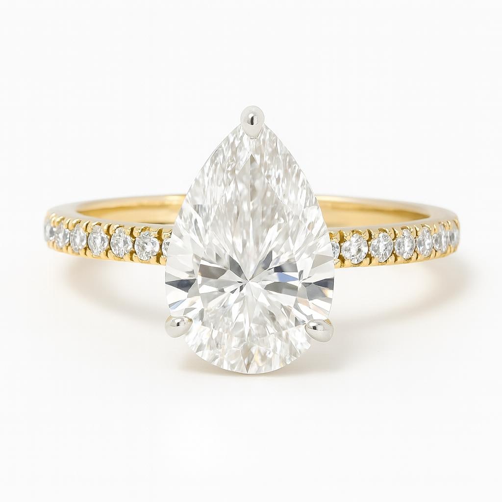4.00 CT Lab Grown Pear Cut Diamond Engagement Ring in 14K Yellow Gold with Diamond Band: Exquisite 4.00 carat lab grown pear cut diamond centerpiece, elegantly set on a 14K yellow gold band adorned with pavé-set round lab grown diamonds. A timeless blend of sparkle and luxury, perfect fo