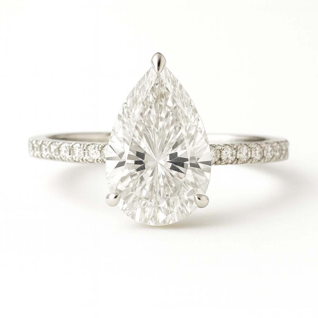 6.00 CT Lab Grown Pear Cut Diamond Ring in 14K White Gold: Stunning 6.00 carat lab grown pear cut diamond, set on a delicate 14K white gold band adorned with pavé diamonds for added brilliance. A timeless and elegant design perfect for any occasion.Color Gra