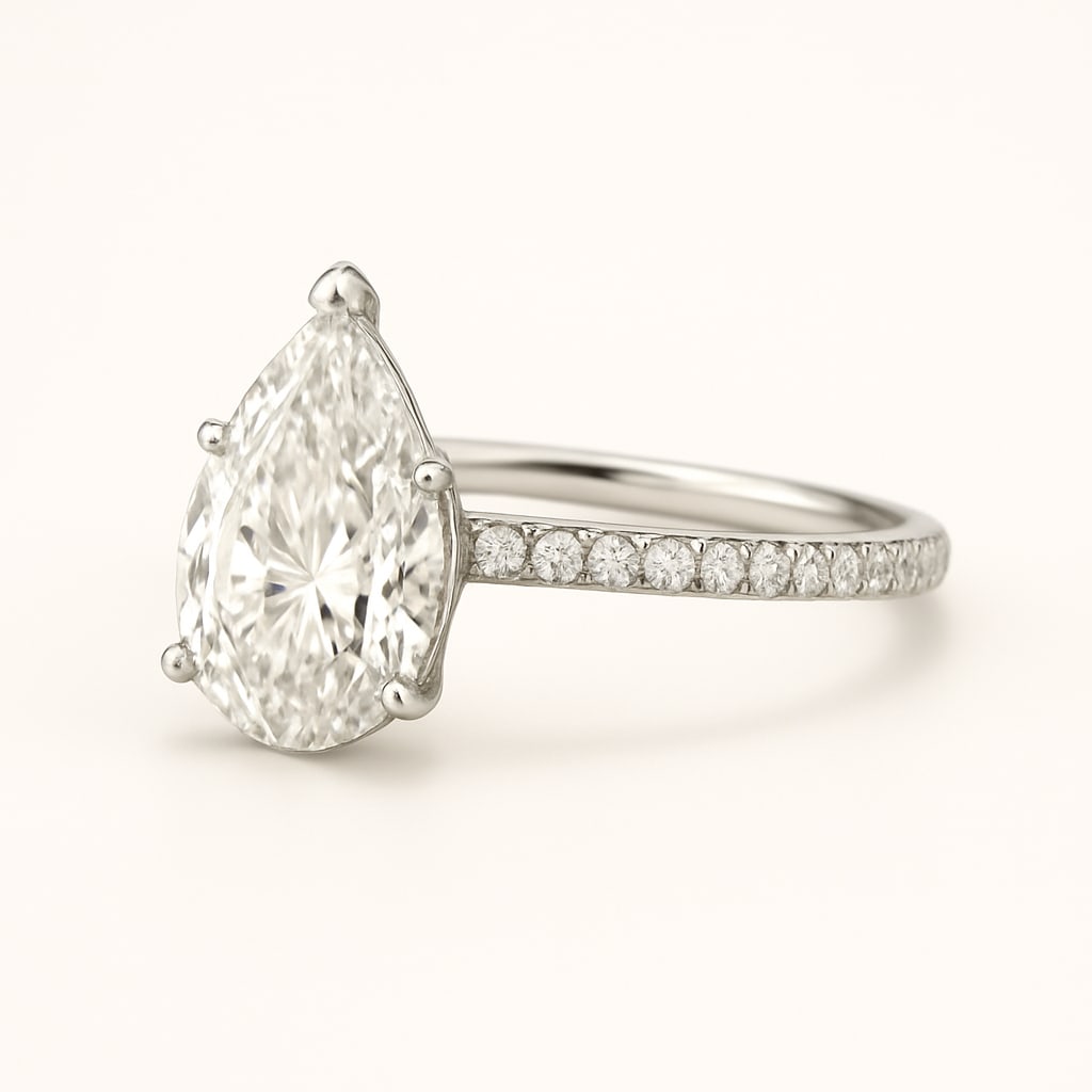 4.00 CT Lab Grown Pear Cut Diamond Solitaire Ring with Pavé Band in 14K White Gold: Beautiful 4.00 carat lab grown pear cut diamond, prong set on a polished 14K white gold pavé band. This elegant solitaire engagement ring highlights the brilliance of the pear shape with timeless sty