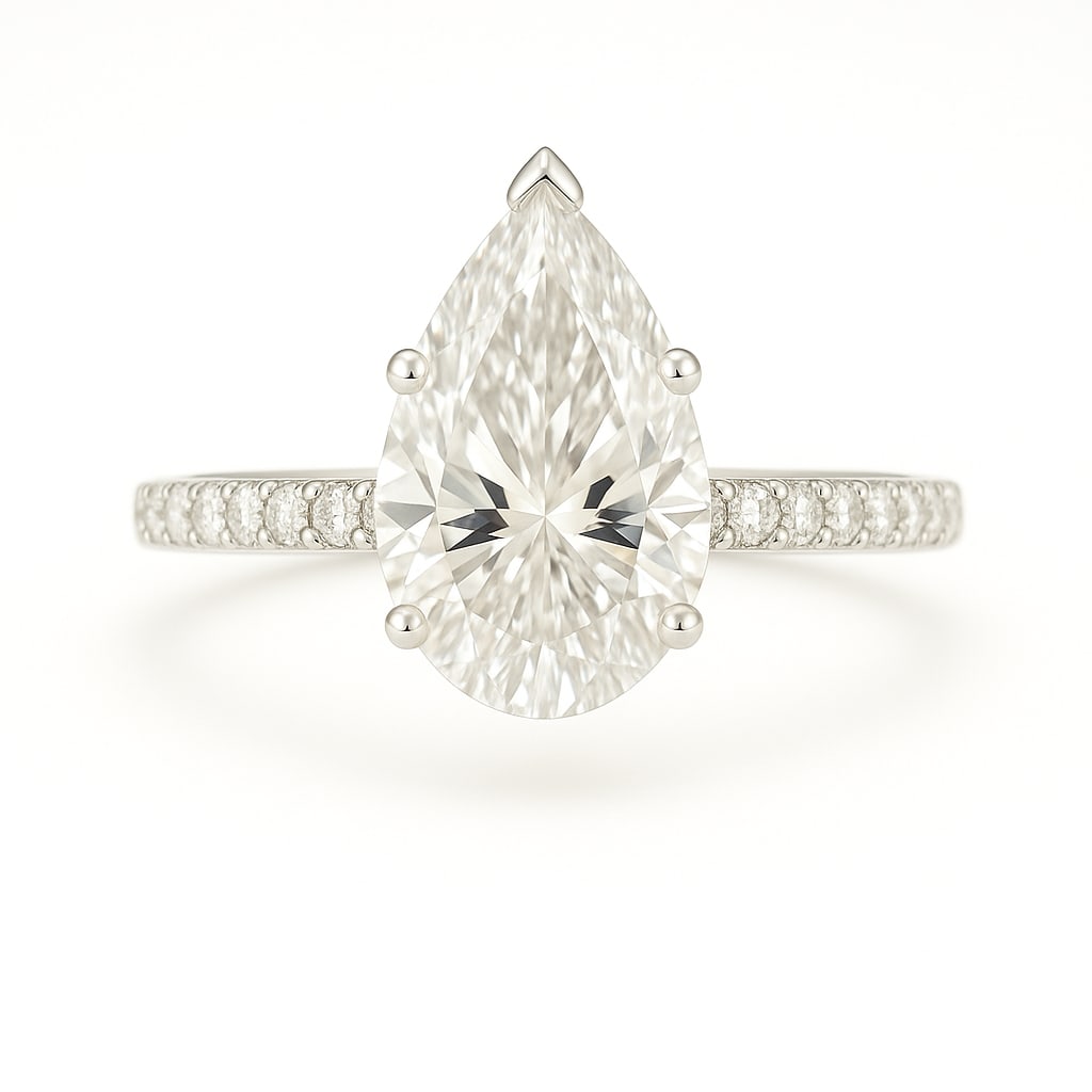 4.50 CT Pear Cut Lab Grown Diamond Solitaire Ring with Pavé Band in 14K White Gold: A graceful 4.50 carat pear cut lab grown diamond sparkles with its elegant teardrop silhouette, set in a classic solitaire design. The pavé-set diamond band enhances the brilliance, while the polishe