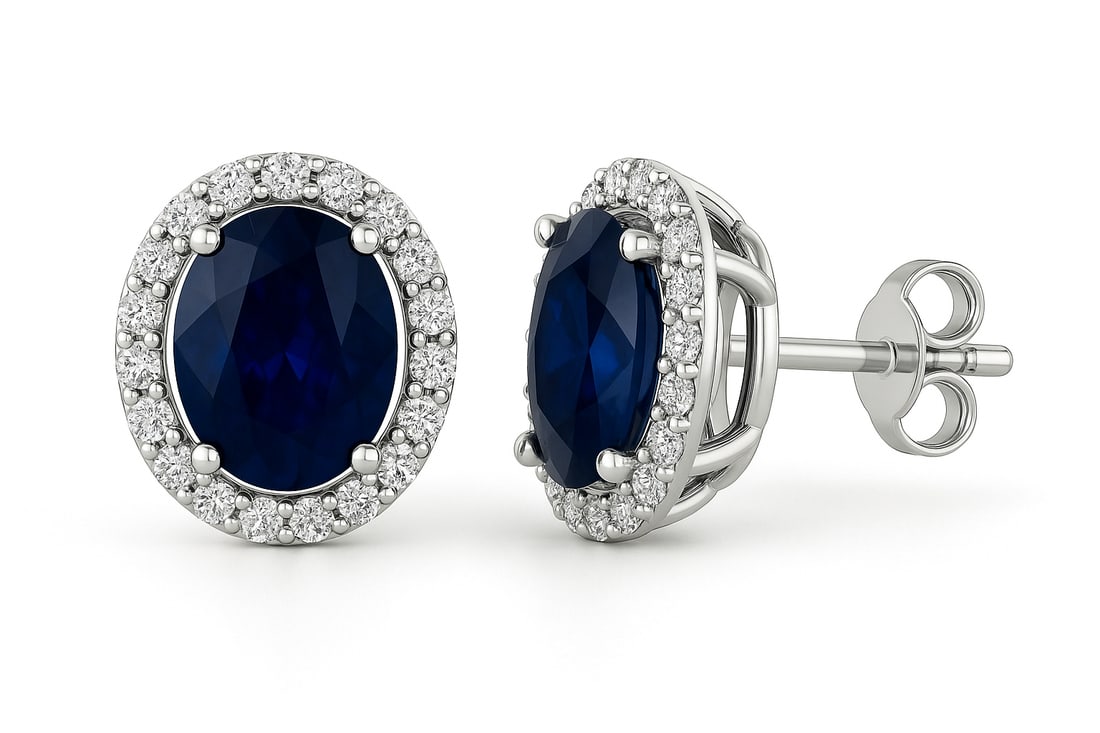 6.00 CT Oval Cut Lab Grown Blue Sapphire Halo Earrings in 14K White Gold: Pair of 6.00 ct oval cut lab grown blue sapphires with diamond halos, set in 14K white gold.