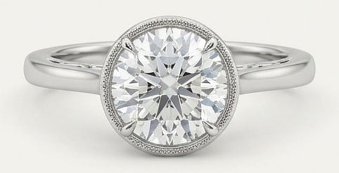 Lab Grown 5.00 Ct Round Brilliant Diamond Ring – Bezel Set Solitaire with Milgrain – / in 14K: Distinctive in silhouette, this ring centers on a 5.00 carat lab grown Round Brilliant center diamond. Featuring the Bezel Set Solitaire with Milgrain design language, giving the piece a memorable, st