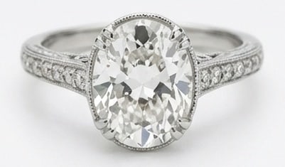 Lab Grown 4.00 Ct Oval Diamond Ring – Vintage Oval Solitaire with Pave Shoulders – / in 14K: Striking and elegant, this ring features a 4.00 carat lab grown Oval center diamond. Featuring the Vintage Oval Solitaire with Pave Shoulders styling that frames the centerpiece and shapes the overall