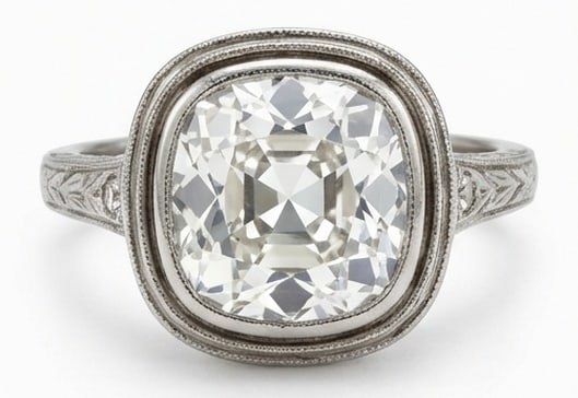 Lab Grown 4.00 Ct Cushion (Old Mine Look) Diamond Ring – Vintage Bezel Set with Engraved Shoulders: Bold yet refined, this design showcases a 4.00 carat lab grown Cushion (Old Mine Look) center diamond. White Gold gives the piece a refined, neutral foundation for daily wear or events. The overall st