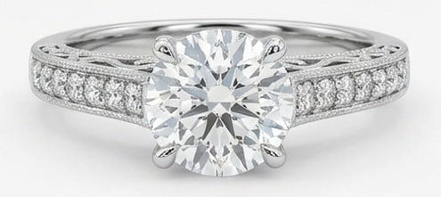 Lab Grown 4.00 Ct Round Brilliant Diamond Ring – Vintage Pave Band with Engraved Profile – / in: Classic with a contemporary edge, this ring spotlights a 4.00 carat lab grown Round Brilliant center diamond. White Gold gives the piece a refined, neutral foundation for daily wear or events. The ove