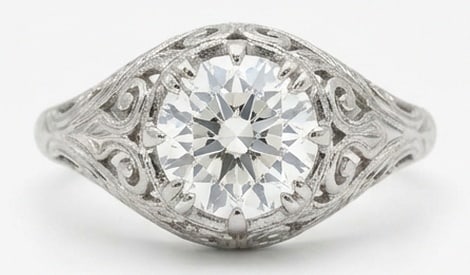 Lab Grown 4.00 Ct Round Brilliant Diamond Ring – Antique Filigree Solitaire with Scroll Details: Bold yet refined, this design showcases a 4.00 carat lab grown Round Brilliant center diamond. White Gold gives the piece a refined, neutral foundation for daily wear or events. The overall style foll