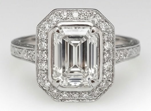 Lab Grown 5.00 Ct Emerald Cut Diamond Ring – Vintage Bezel Set Halo with Engraved Shank – / in: Designed to stand out, this ring presents a 5.00 carat lab grown Emerald Cut center diamond. Set in White Gold , the ring is styled with vintage bezel set halo with engraved shank details that define 