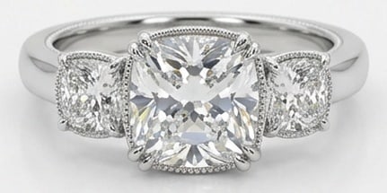 Lab Grown 5.00 Ct Cushion (Modified Brilliant) Diamond Ring – Classic Three-Stone Cushion with: Sophisticated and modern, this ring is defined by a 5.00 carat lab grown Cushion (Modified Brilliant) center diamond. Featuring the Classic Three-Stone Cushion with Milgrain Edges theme, offering a di