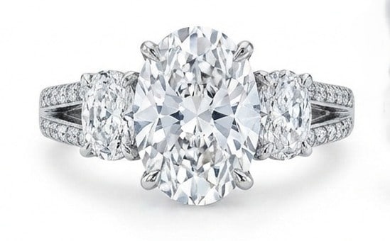 Lab Grown 6.00 Ct Oval Diamond Ring – Vintage Three-Stone Oval with Split Shank Pave – / in 14K: Striking and elegant, this ring features a 6.00 carat lab grown Oval center diamond. Featuring the Vintage Three-Stone Oval with Split Shank Pave styling that frames the centerpiece and shapes the ove