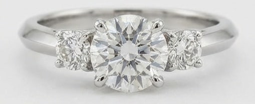 Lab Grown 4.00 Ct Round Brilliant Diamond Ring – Classic Three-Stone Round with Knife-Edge Band: Sophisticated and modern, this ring is defined by a 4.00 carat lab grown Round Brilliant center diamond as the focal point. The classic three-stone round with knife-edge band design is paired with Whi