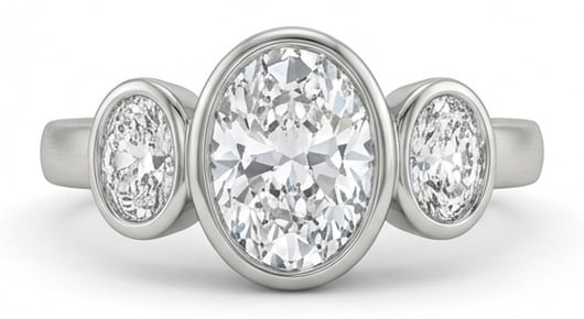 Lab Grown 3.00 Ct Oval Diamond Ring – Modern Bezel Set Three-Stone Oval – / in 14K White Gold: Sophisticated and modern, this ring is defined by a 3.00 carat lab grown Oval center diamond. Featuring the Modern Bezel Set Three-Stone Oval theme, offering a distinctive top view and refined styling