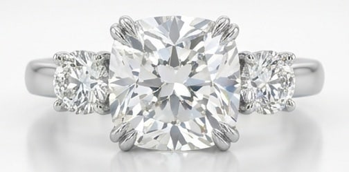 Lab Grown 4.00 Ct Cushion (Modified Brilliant) Diamond Ring – Three-Stone Cushion with Round Sides: Sophisticated and modern, this ring is defined by a 4.00 carat lab grown Cushion (Modified Brilliant) center diamond as the focal point. The three-stone cushion with round sides design is paired with 