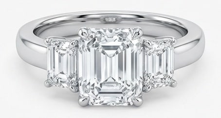 Lab Grown 3.00 Ct Emerald Cut Diamond Ring – Classic Three-Stone Emerald Cut – / in 14K White: Classic with a contemporary edge, this ring spotlights a 3.00 carat lab grown Emerald Cut center diamond. White Gold gives the piece a refined, neutral foundation for daily wear or events. The overall