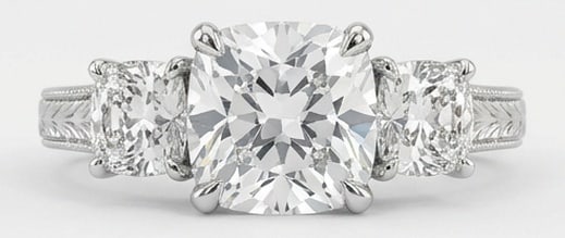 Lab Grown 4.00 Ct Cushion (Old Mine Look) Diamond Ring – Vintage Three-Stone Cushion with Engraved: Bold yet refined, this design showcases a 4.00 carat lab grown Cushion (Old Mine Look) center diamond. White Gold gives the piece a refined, neutral foundation for daily wear or events. The overall st