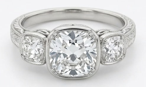 Lab Grown 4.00 Ct Cushion (Old Mine Look) Diamond Ring – Vintage Three-Stone Cushion Bezel Set –: Sophisticated and modern, this ring is defined by a 4.00 carat lab grown Cushion (Old Mine Look) center diamond. Featuring the Vintage Three-Stone Cushion Bezel Set theme, offering a distinctive top v