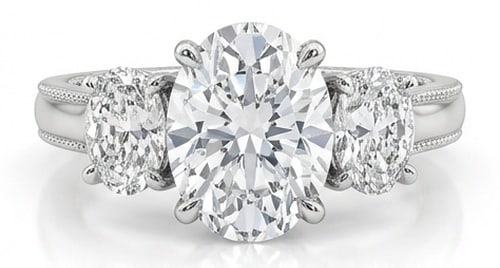 Lab Grown 5.00 Ct Oval Diamond Ring – Three-stone setting with milgrain detail on shank shoulders: Striking and elegant, this ring features a 5.00 carat lab grown Oval center diamond. Featuring the Three-stone setting with milgrain detail on shank shoulders styling that frames the centerpiece and s