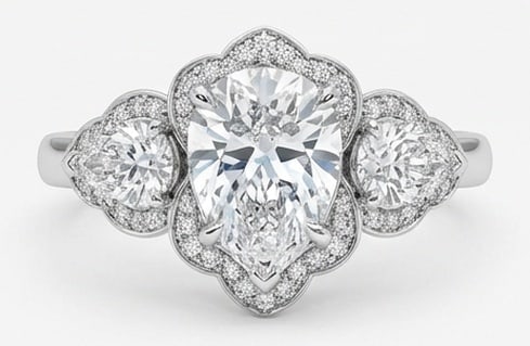 Lab Grown 4.00 Ct Pear Diamond Ring – Ornate scalloped/floral halo three-stone setting with: A timeless statement, this ring highlights a 4.00 carat lab grown Pear center diamond as the focal point. The ornate scalloped floral halo three-stone setting with milgrain design is paired with White