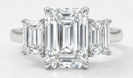 Lab Grown 6.00 Ct Emerald Diamond Ring – Classic three-stone setting with emerald-cut side stones: A timeless statement, this ring highlights a 6.00 carat lab grown Emerald center diamond. Featuring Classic three-stone setting with emerald-cut side stones and plain band elements that bring depth an