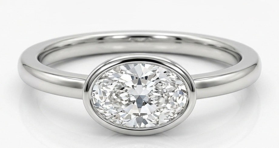 Lab Grown 2.00 Ct Oval Diamond Ring – Modern East-West full bezel setting with plain rounded band: Classic with a contemporary edge, this ring spotlights a 2.00 carat lab grown Oval center diamond. White Gold gives the piece a refined, neutral foundation for daily wear or events. The overall style 