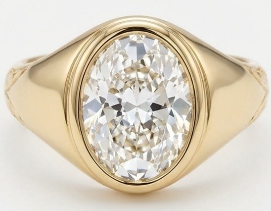 Lab Grown 5.00 Ct Oval Diamond Ring – Heavy signet-style bezel setting with engraved details on: Bold yet refined, this design showcases a 5.00 carat lab grown Oval center diamond. Yellow Gold gives the piece a refined, neutral foundation for daily wear or events. The overall style follows a heav