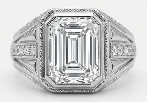 Lab Grown 6.00 Ct Emerald Diamond Ring – Art Deco architectural setting with bezel center and: Designed to stand out, this ring presents a 6.00 carat lab grown Emerald center diamond. Set in White Gold, the ring is styled with art deco architectural setting with bezel center and geometric diamo