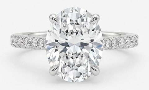 Lab Grown 6.00 Ct Oval Diamond Ring – Oval solitaire with pave-set diamond band – in 14K White: Graceful and eye-catching, this ring is set with a 6.00 carat lab grown Oval center diamond. White Gold gives the piece a refined, neutral foundation for daily wear or events. The overall style follow