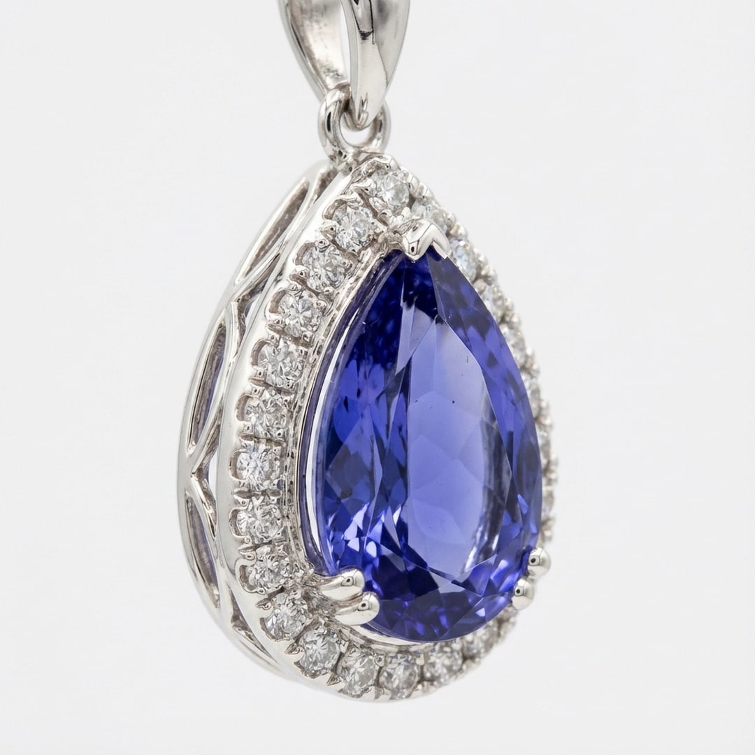 2.0 Ct Pear Natural Tanzanite 14K White Gold Pendant with Decorative Halo - Certified: This certified fine jewelry piece features a 2.0 carat natural Tanzanite in a Pear cut, crafted in 14K White Gold. The Pendant with Decorative Halo design highlights the beauty of the natural center s