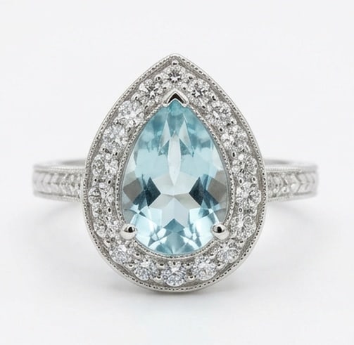 2.0 Ct Pear Natural Aquamarine 14K White Gold Vintage Halo with Engraved Shank Ring - Certified: This certified fine jewelry piece features a 2.0 carat natural Aquamarine in a Pear cut, crafted in 14K White Gold. The Vintage Halo with Engraved Shank design highlights the beauty of the natural cen