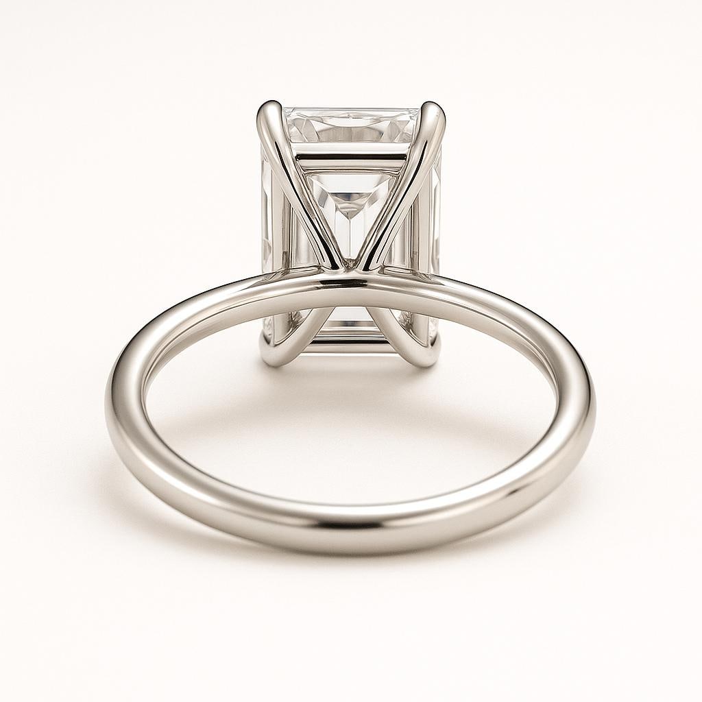 4.50 CT Lab Grown Emerald Cut Diamond Solitaire Ring in 14K White Gold: Elegant 4.50 carat lab grown emerald cut diamond, showcased in a four-prong polished 14K white gold band. This solitaire ring highlights the clean step-cut facets and timeless sophistication of the em