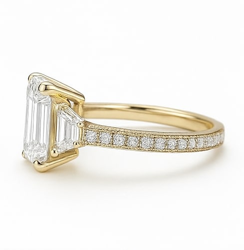 8.50 CT Lab Grown Emerald Cut Diamond Three-Stone Ring with Trapezoid Side Stones in 14K Yellow Gold: Magnificent 8.50 carat lab grown emerald cut diamond, flanked by trapezoid-shaped side stones and set on a polished 14K yellow gold band with pavé accents. A luxurious engagement ring that exudes sop