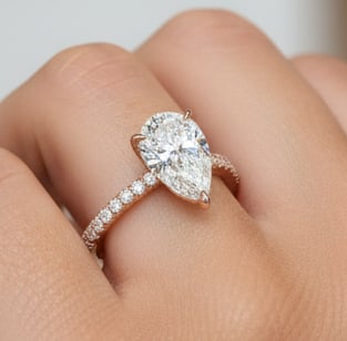 8.00 CT Pear-Cut lab-grown diamond Diamond Rose Gold Engagement Ring: A stunning 8.00 carat lab-grown diamond pear-cut diamond showcased in a sleek 14K rose gold solitaire setting, paired with a pav? diamond band for added brilliance. Designed with a secure prong settin