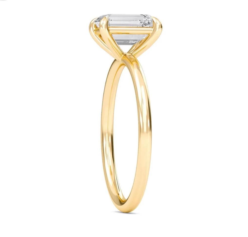 5.00 CT Emerald-Cut lab-grown diamond Diamond Solitaire Ring in 14K Yellow Gold: This refined solitaire ring features a 5.00 carat emerald-cut lab-grown diamond diamond in a classic four-prong setting, mounted on a slender 14K yellow gold band with a high-polish finish. The step-c
