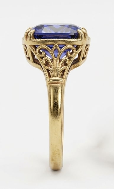 3.0 Ct Cushion Natural Tanzanite 14K Yellow Gold Vintage Scroll/Filigree Solitaire Ring - Certified: This certified fine jewelry piece features a 3.0 carat natural Tanzanite in a Cushion cut, crafted in 14K Yellow Gold. The Vintage Scroll/Filigree Solitaire design highlights the beauty of the natural
