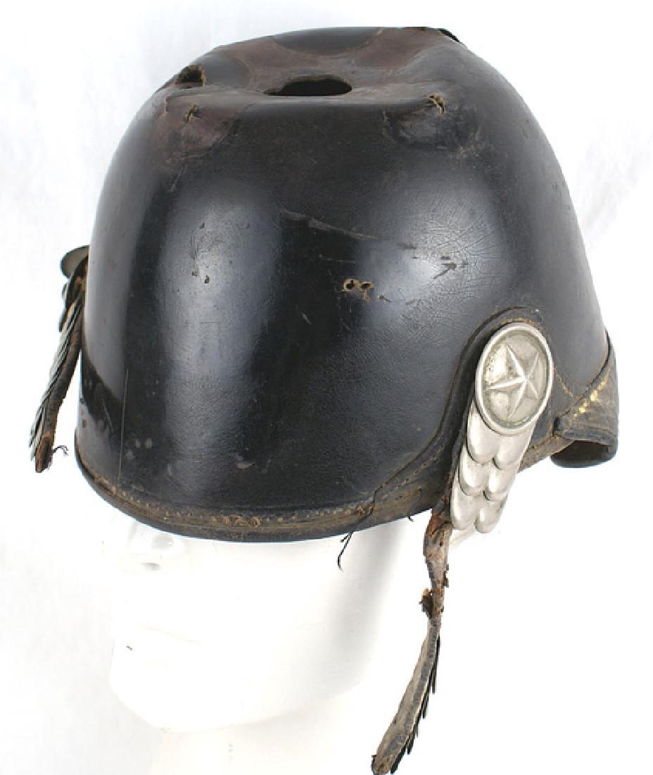 American spiked helmet Circa 1880s: K-073 American spiked helmet. A direct copy of the German pickelhaube. Black patent leather mellon-shaped skull and back visor (slightly curled). Missing front visor. Impression is clearly visible whe