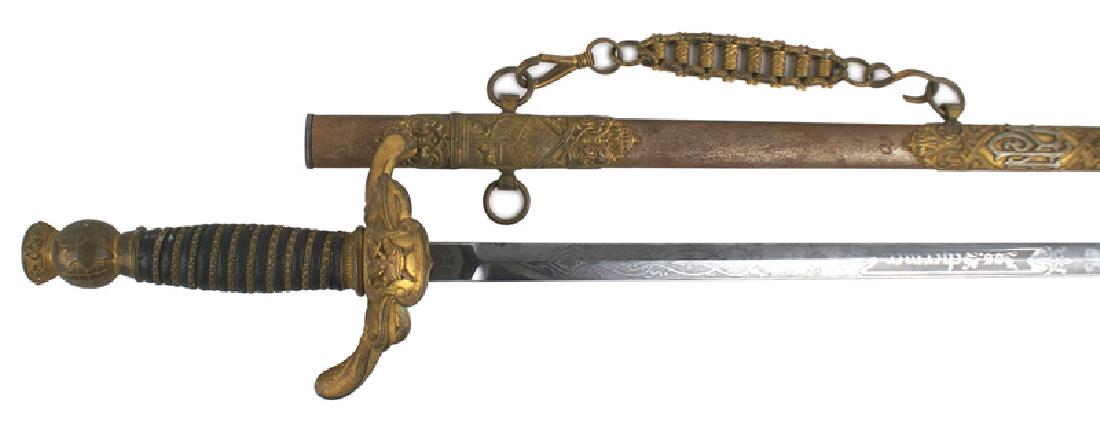 Knights of Pithius sword: K-096 Knights of Pithius sword. Age darkened gilt globe pommel and floral "S"-shaped crossguard/langet with a crown, etc. Star decorated flat wire wrapped black leather grip. Fairly clean 30 1/8" blad