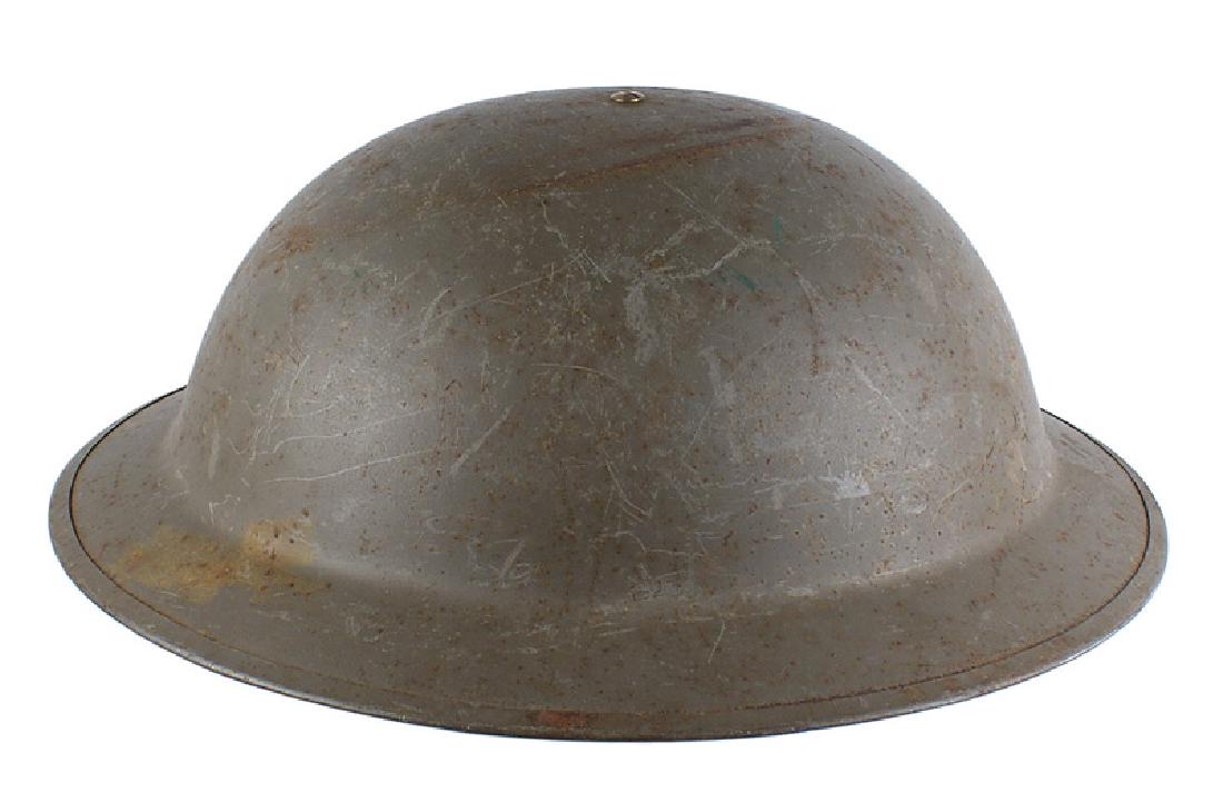 U.S. M1917 A1 helmet: E-039 U.S. M1917 A1 helmet. Smooth O.D. finish. Top center rivet holds a black 4 leather "tongue" liner. Web chinstrap. Some scratches and "dimples". About II