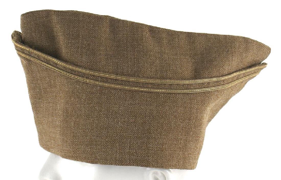 French WWI M1918 officer Forage cap: E-111 French WWI M1918 khaki officer's forage cap - more of an O.D. color. High front and back "peak". Light brown silk-like lining. One small "nip" - otherwise excellent. (This khaki type cap was iss
