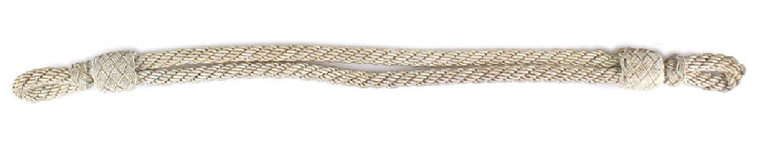 German WWII officer peaked cap chincord: E-135 White-silver German WWII Officer's peaked cap chin cord. Probably for a Red Cross Officer's cap. II