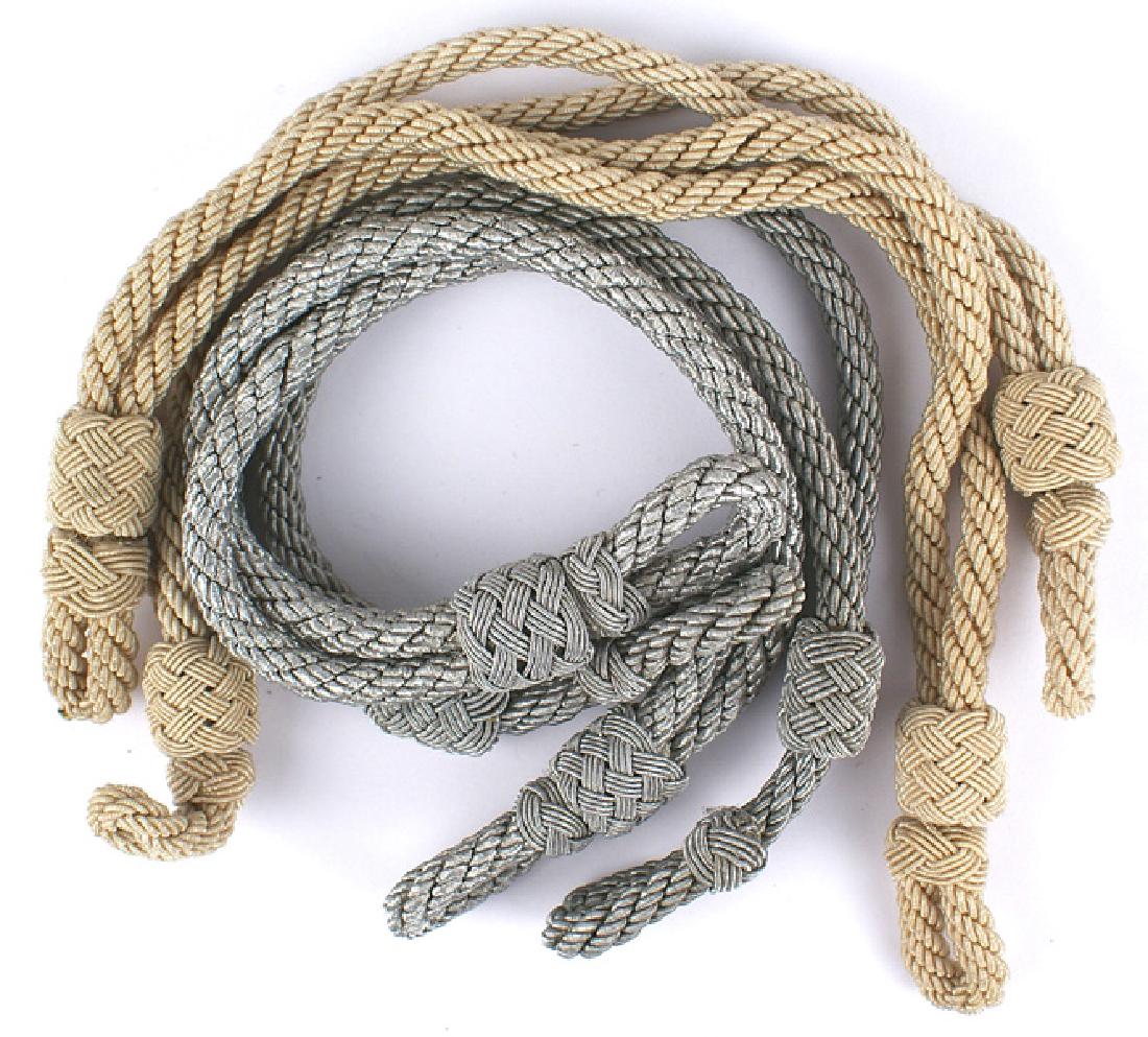 German WWII officer peaked cap cords lot: E-138 Lot of 4 German WWII Officer peaked cap cords: (1) Two Army/Luftwaffe silver bullion type. (2) Two bullion type but a lighter almost off-white/tan appearance. Possibly used on the Red Cross Offi