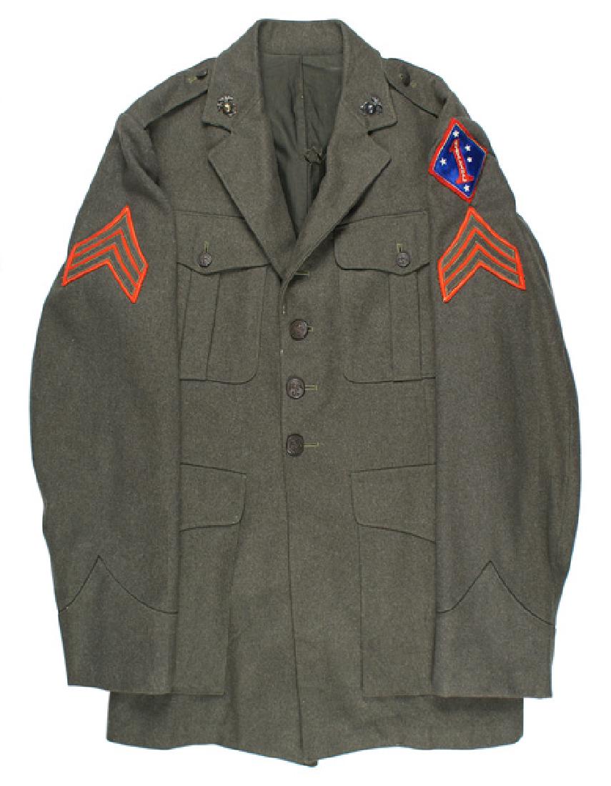 U.S. Marine Corps WWII tunic: F-067 U.S. Marine Corps WWII four-pocket green wool tunic. Embroidered 1st Division patch, on a red field, on left shoulder. Also Sergeant stripes and darkened EGA collar insignia. Two small moth "bit
