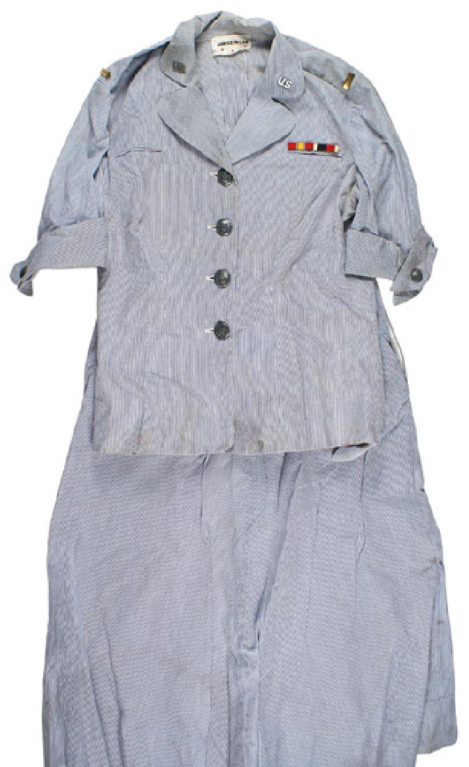 Lot of U.S. post-war nurse uniforms: F-087 Lot of U.S. post-war nurse's uniforms: (1) Blue/white striped nurse's dress. With a white blouse, bib and apron (soiled and should be cleaned). Includes a blue hood and cloth pouch. Named. (2) N