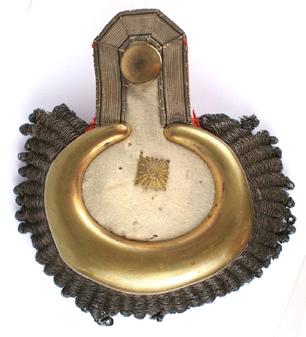 Prussian Cuirassier epaulette: F-112 Imperial Prussian Cuirassier single dress "banjo"-type epaulette. Large age toned gilt brass crescent surrounding a white cloth field (small "nips") with one affixed large age toned gilt "pip".