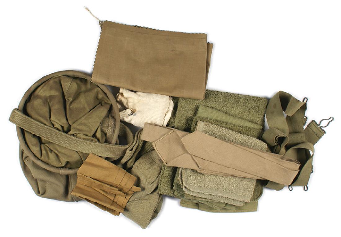 U.S. WWII lot of equipment suspenders etc: F-156 U.S. WWII lot of miscellaneous equipment: (1) OD trouser suspenders with wire formed fasteners. (2) OD web water bucket. Dated "1942". With carrying handle. (3) 11 1/4" x 16 3/4" inflatable canv