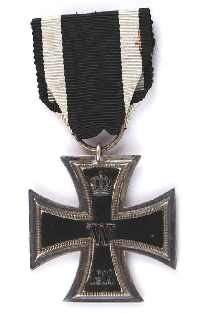 German 1914 Iron Cross 2nd Class Medal: B-007 German 1914 Iron Cross 2nd Class. Black enameled center with a relief crown, "W" and "1914". Reverse has a relief crown, "FW", oak leaves and "1813". Nice patina on the silver frame. Ring is mar