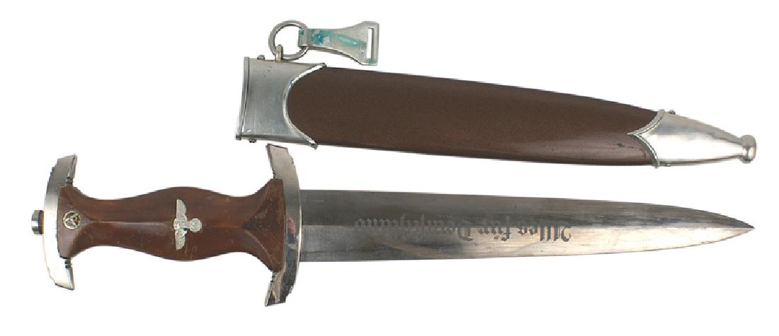 German WWII SA dagger: D-003 German WWII SA dagger. Lacquered rosewood grip with an enameled SA roundel and silvered eagle/swastika. Some patina on the nickeled throat and tip. Nickeled top and lower crossguards. About exce