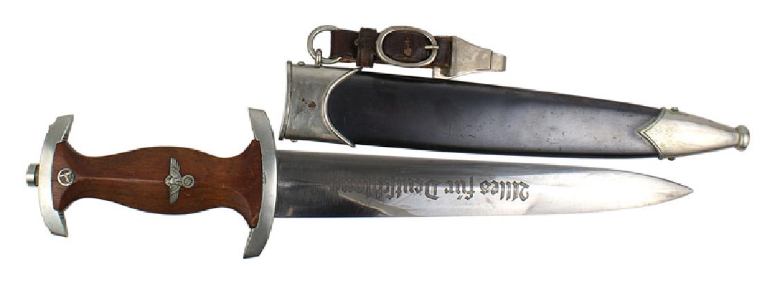German WWII NSKK EM dagger: D-009 German WWII NSKK EM dagger. Same type as the SA dagger. Rosewood grip with a silvered eagle/swastika and "SA" insignia. Light patina on both crossguards. Lower is marked "Th" (Thuringen). Clean 